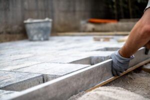 Workers finishing a concrete patio surface during the installation process in Keller, TX