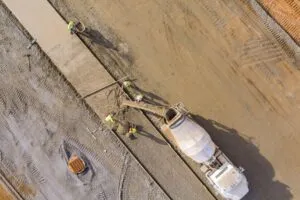 Preparing a concrete foundation with rebar before pouring in hot Texas summer conditions